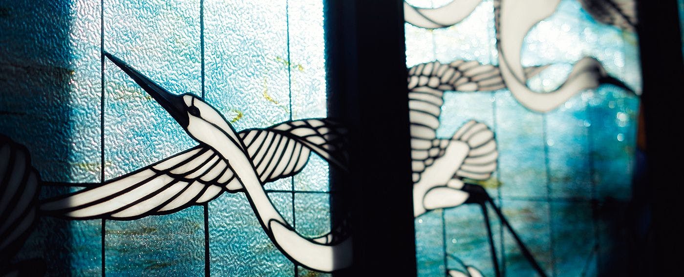 Cahaya lembut menyinari dari kaca berwarna yang menghiasi seluruh dinding.