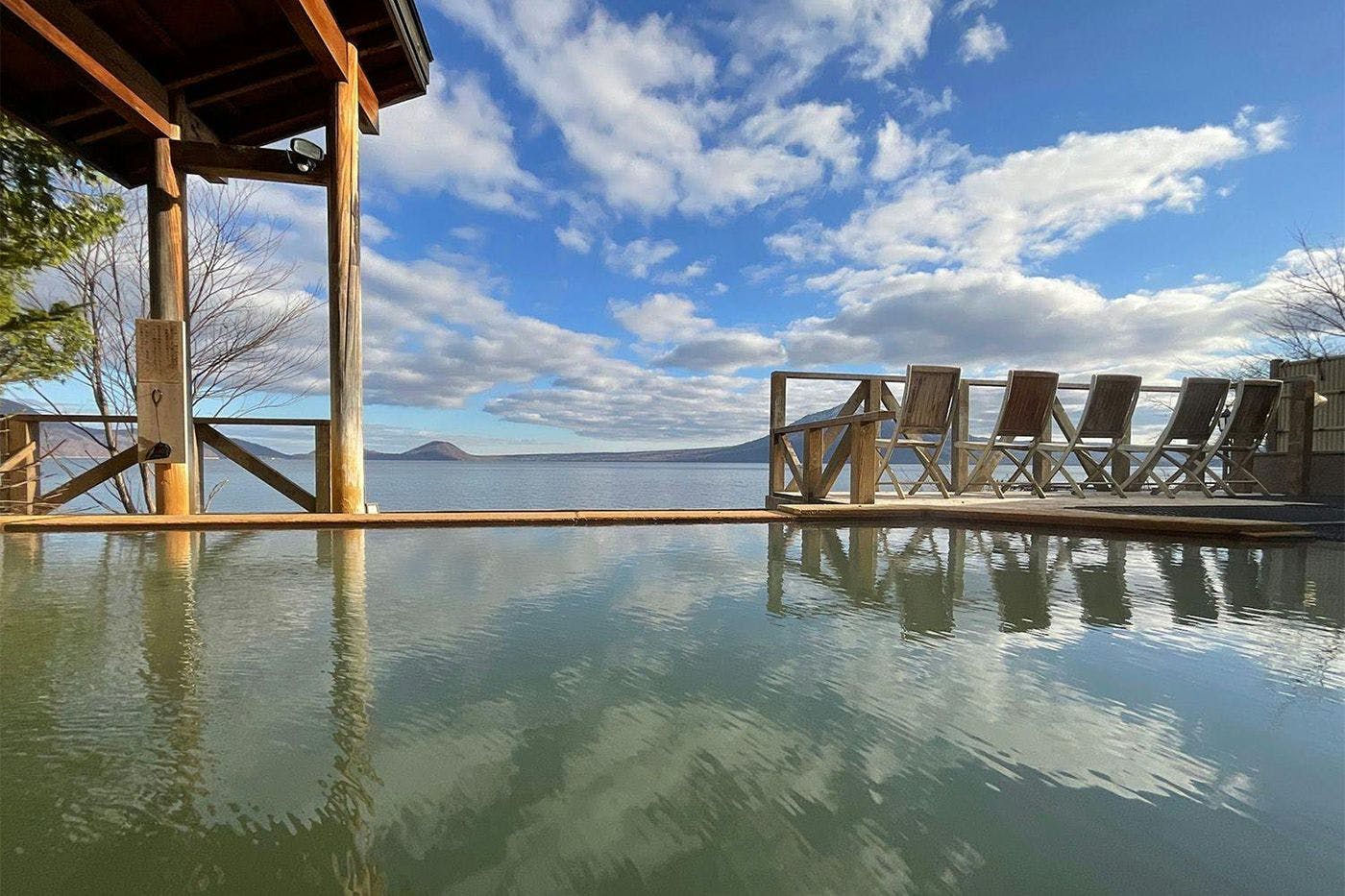 Pemandian umum pria dengan pemandangan luar ruangan.