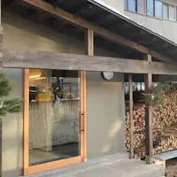 Property entrance with a firewood shed