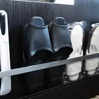 A shoehorn and slippers are provided under the full-length mirror.