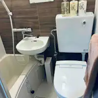 Bathroom with shower and bathtub with reheating function