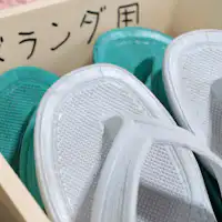 มีรองเท้าแตะสำหรับระเบียงในห้องพัก.