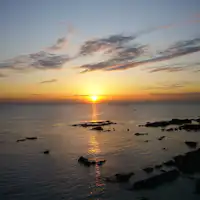 พระอาทิตย์ตกที่ท่าจอดเรือซาจิมะ