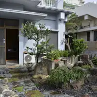 Di samping pintu masuk terdapat taman.
