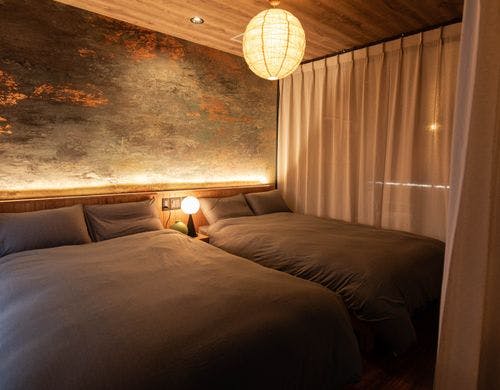 シックな色合いの広々としたベッドルーム