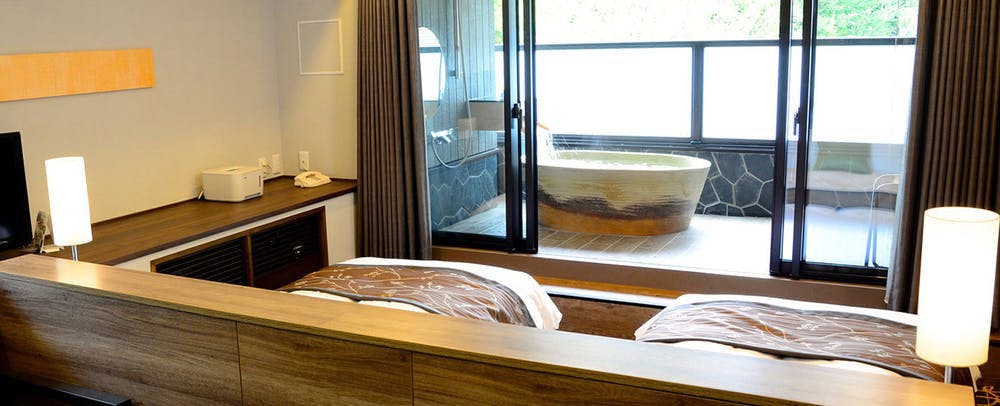 Kamar dengan pemandian terbuka di teras dengan air panas alami untuk kecantikan kulit.