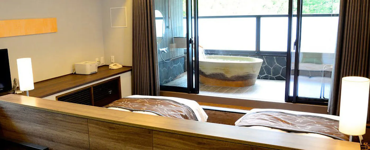 Kamar dengan pemandian terbuka di teras dengan air panas alami untuk kecantikan kulit.