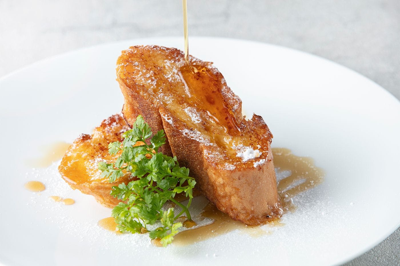 French toast made with "Parisian" French bread, crispy on the outside and fluffy on the inside.