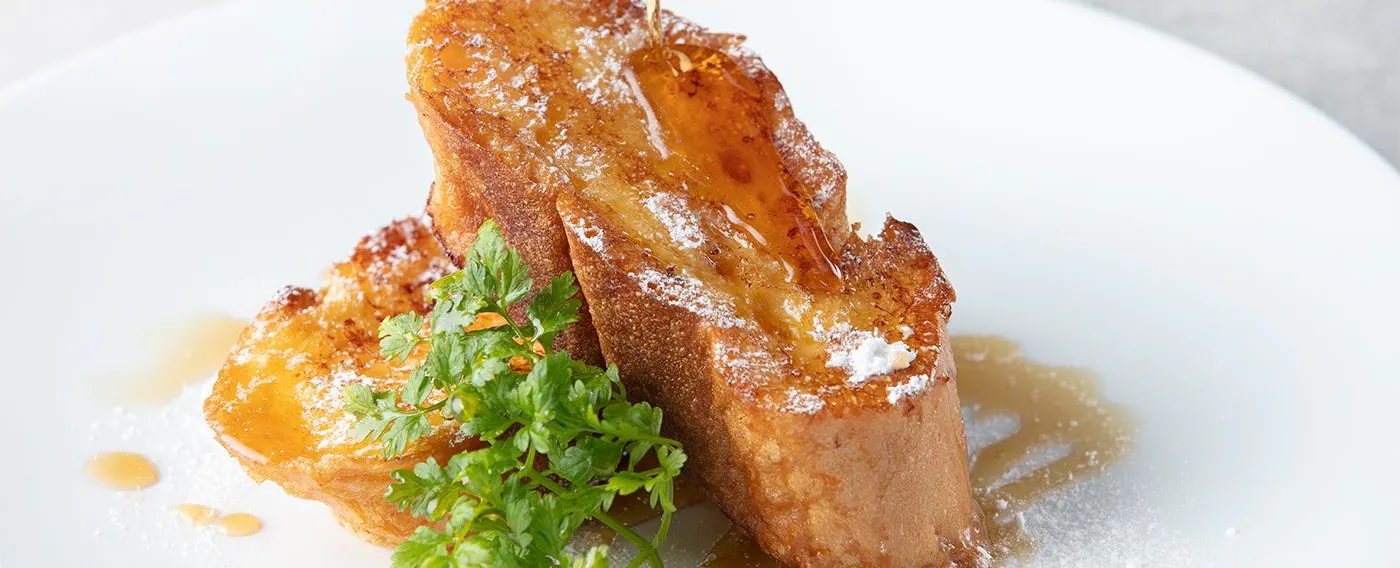 French toast made with "Parisian" French bread, crispy on the outside and fluffy on the inside.