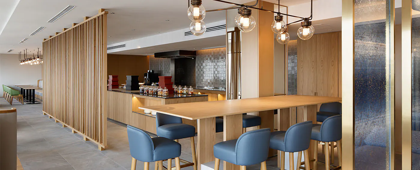 The lounge is divided into a living area, library, meeting area, and casual dining corner.